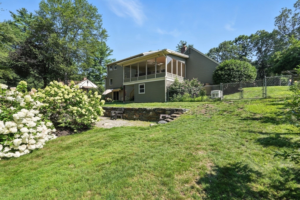 53 Yankee Circle Westfield, MA 01085 - Photo 37 of 42 a yellow house with green field in front of it