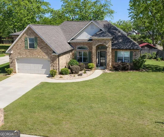 a front view of a house with a garden and porch