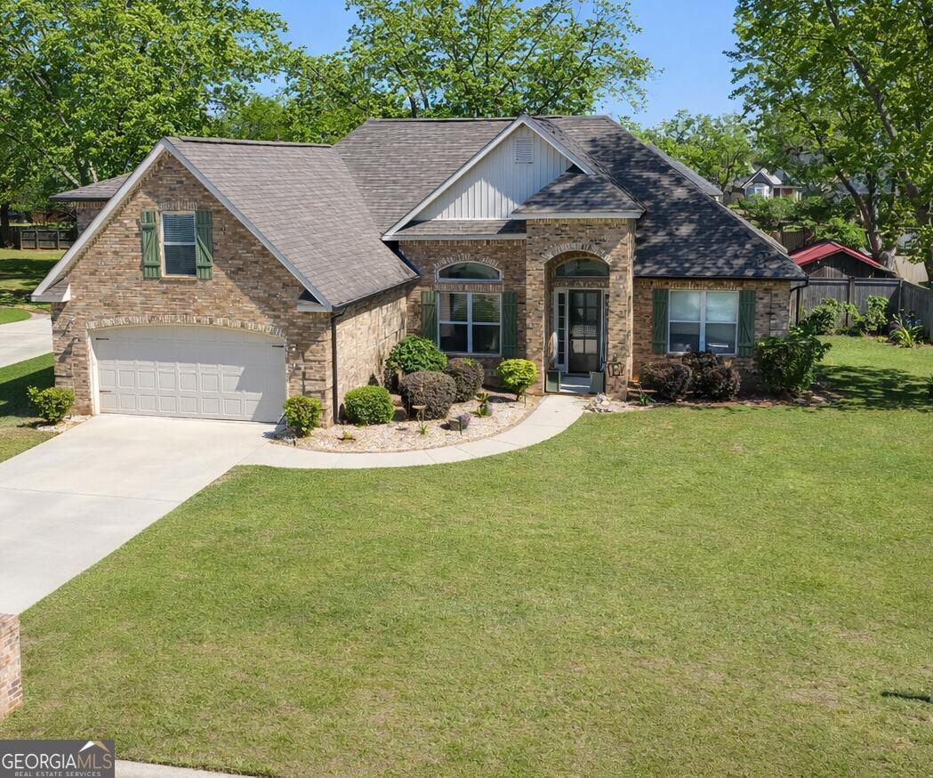 a front view of a house with a garden and porch
