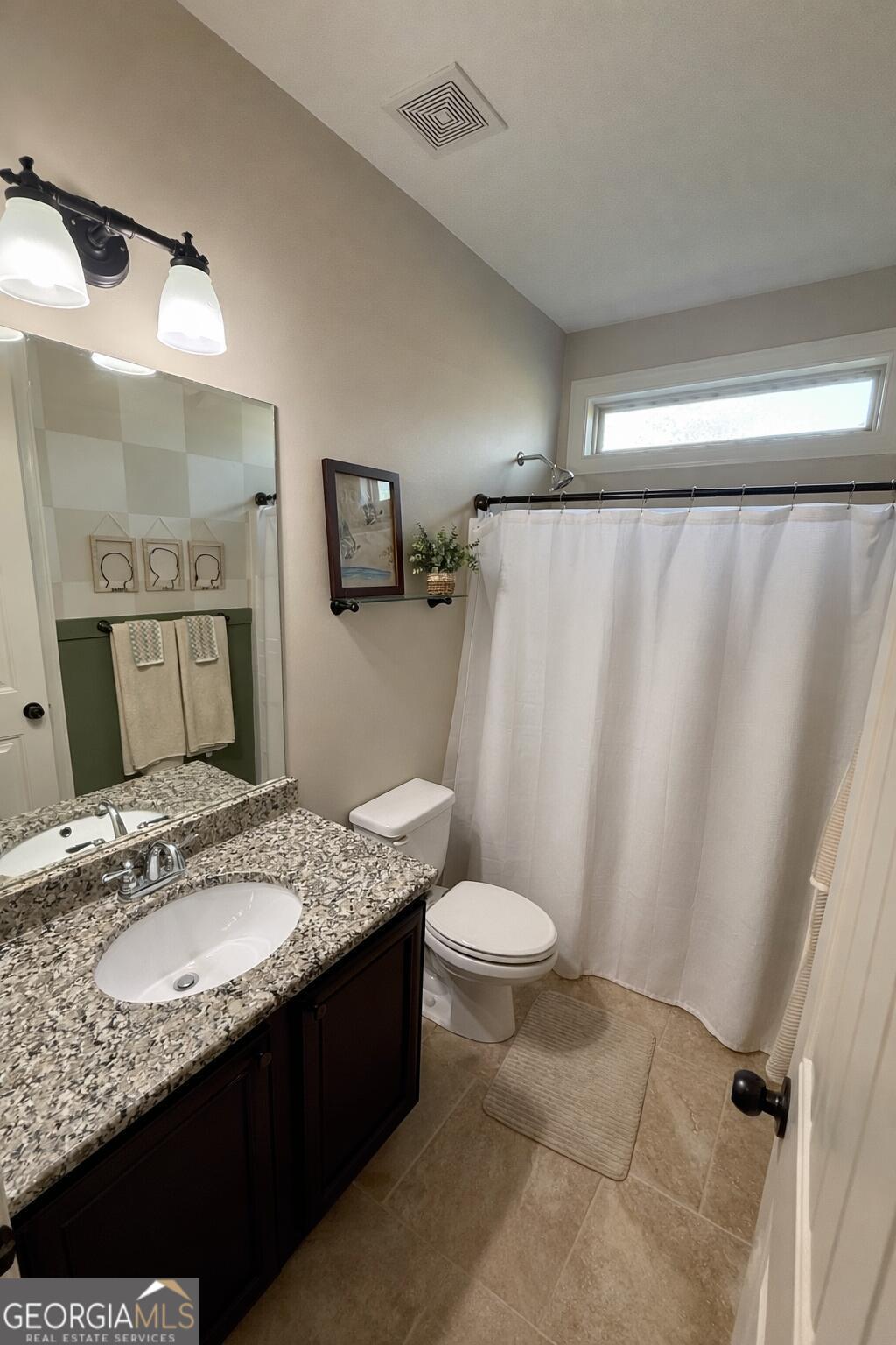 106 Rawlins Point Perry, GA 31069 - Photo 21 of 34 a bathroom with a granite countertop sink and a mirror