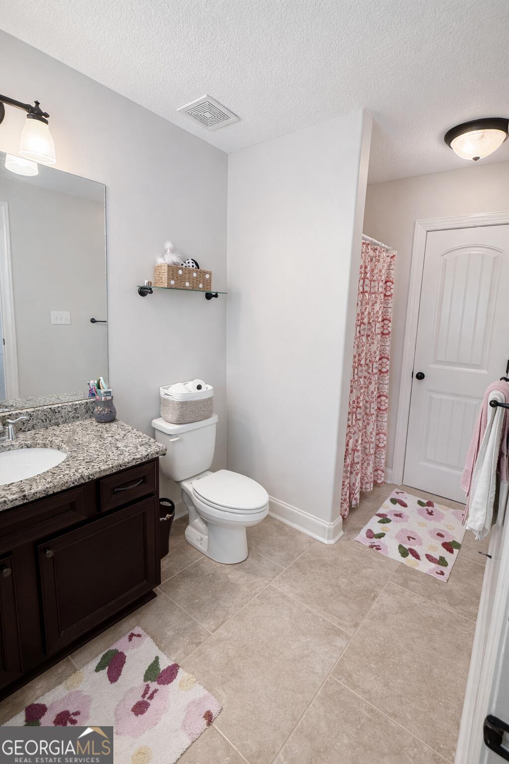 106 Rawlins Point Perry, GA 31069 - Photo 26 of 34 a bathroom with a sink a toilet and shower curtain