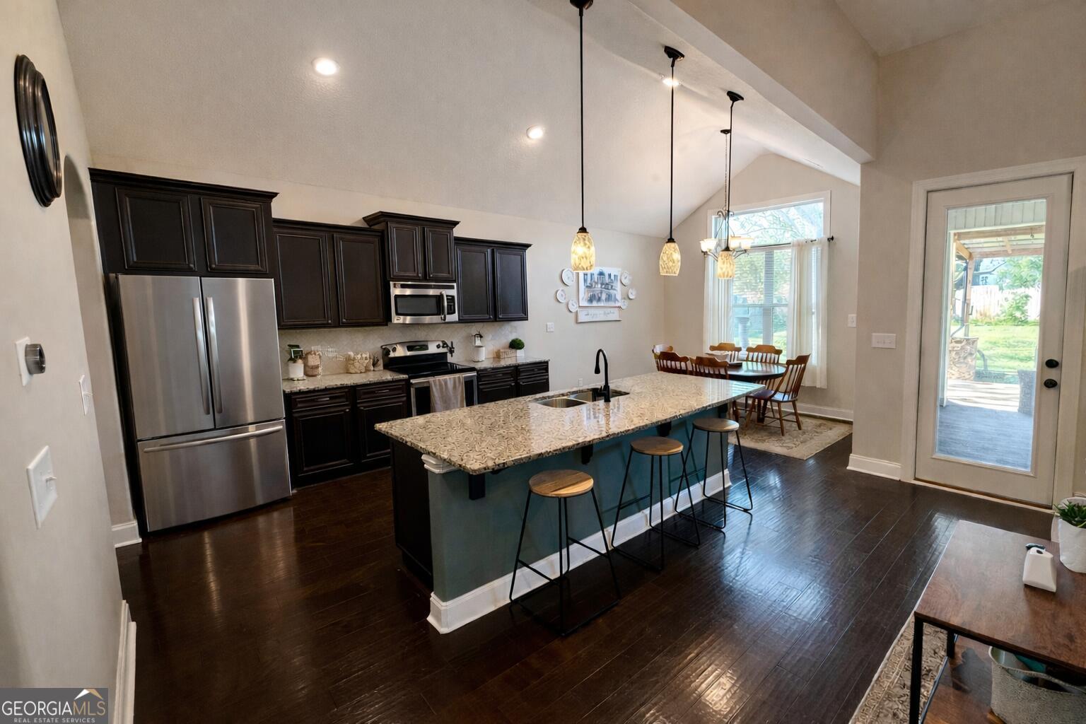 106 Rawlins Point Perry, GA 31069 - Photo 5 of 34 a kitchen with stainless steel appliances a refrigerator a stove a sink dishwasher a oven with white cabinets and wooden floor