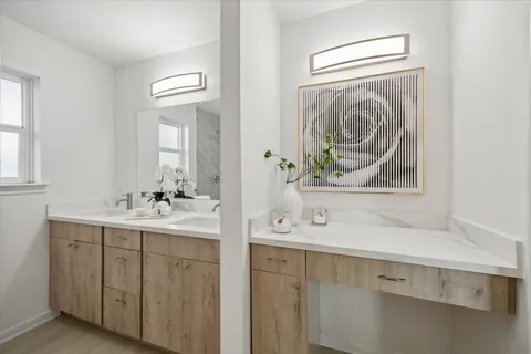 a bathroom with a sink a mirror and a window