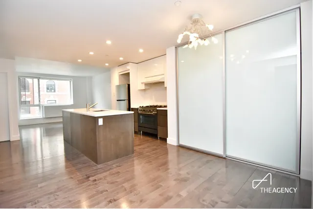 a kitchen with kitchen island a counter top space appliances and cabinets