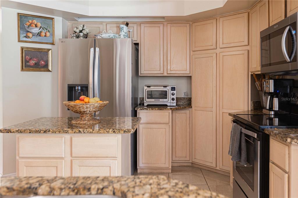 1915 Southwest 40th Place Ocala, FL 34471 - Photo 11 of 20 a kitchen with stainless steel appliances granite countertop a refrigerator sink and stove
