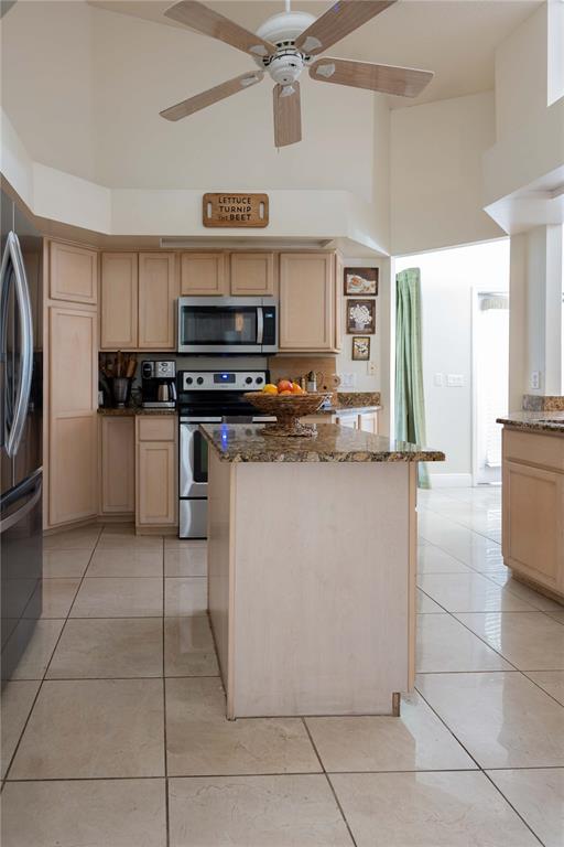 1915 Southwest 40th Place Ocala, FL 34471 - Photo 13 of 20 a kitchen with stainless steel appliances granite countertop a refrigerator and a stove top oven