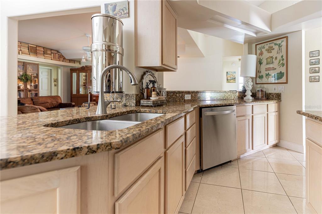 1915 Southwest 40th Place Ocala, FL 34471 - Photo 14 of 20 a kitchen with stainless steel appliances granite countertop a sink stove and cabinets