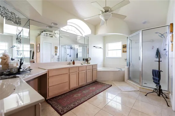 a large bathroom with a double vanity sink a mirror and a bathtub