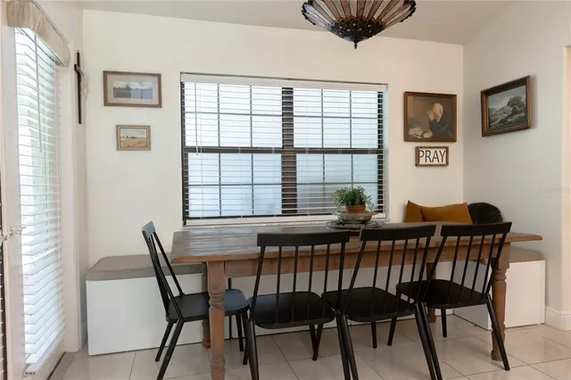 a bed room with a bed a television and large window