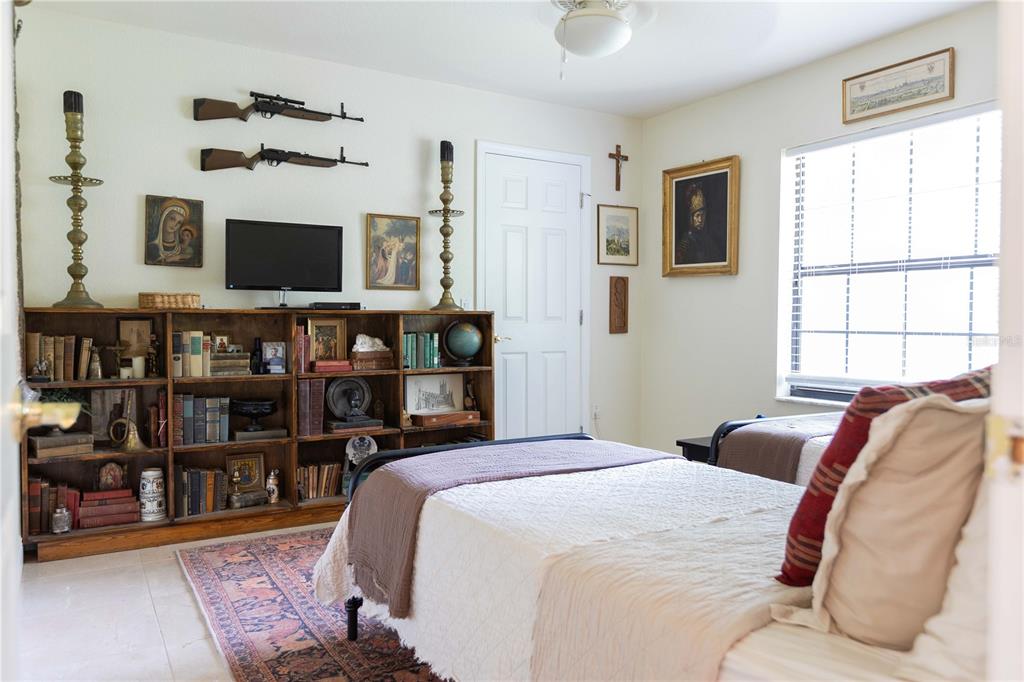 1915 Southwest 40th Place Ocala, FL 34471 - Photo 6 of 20 a bed room with a bed a television and large window