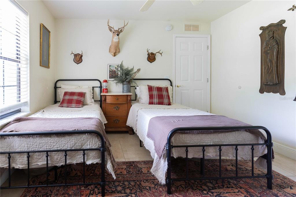 1915 Southwest 40th Place Ocala, FL 34471 - Photo 7 of 20 a bedroom with a bed a flat screen tv and dresser