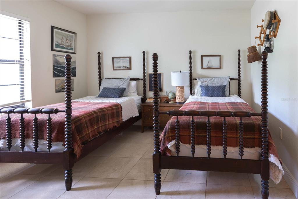 1915 Southwest 40th Place Ocala, FL 34471 - Photo 8 of 20 a bedroom with two beds and potted plants