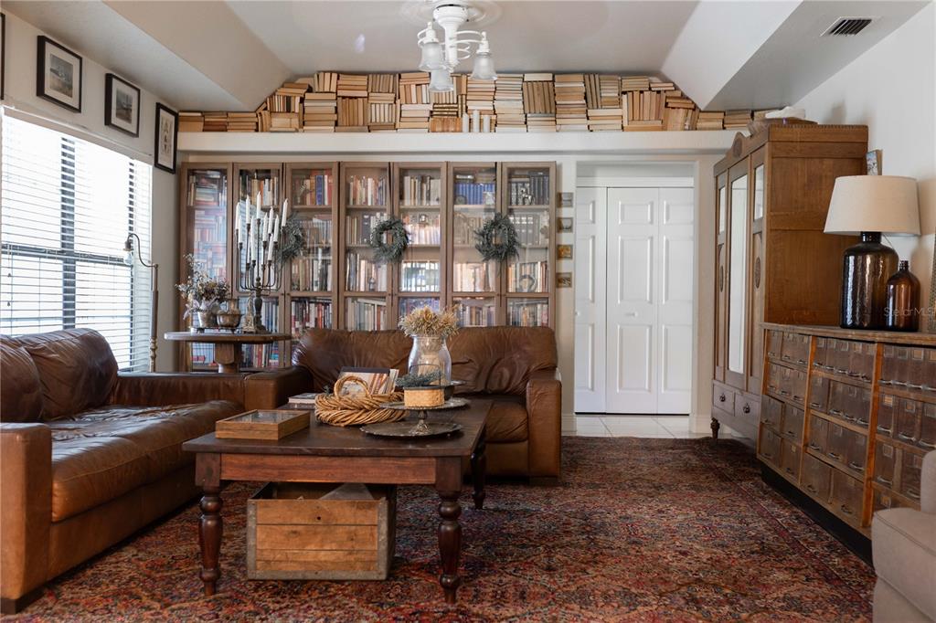 1915 Southwest 40th Place Ocala, FL 34471 - Photo 10 of 20 a living room with furniture a chandelier and a table
