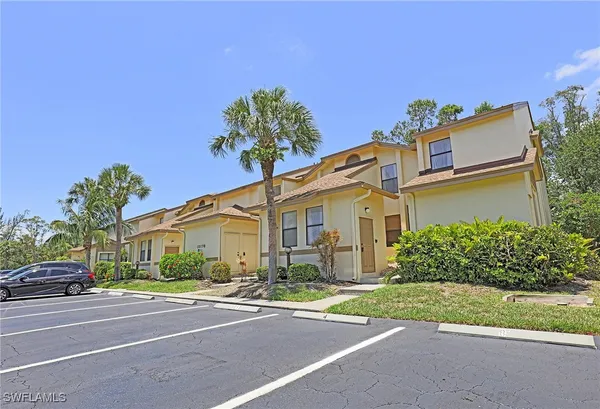 a front view of a house with a yard and a garage