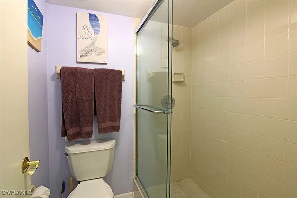 a bathroom with a toilet and a shower