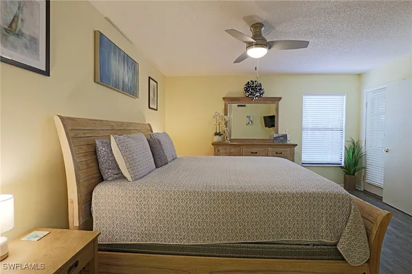 a bed room with a bed and a chandelier