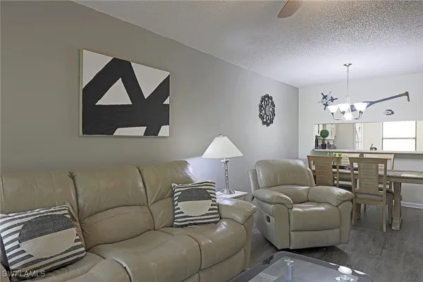 a living room with furniture and a lamp