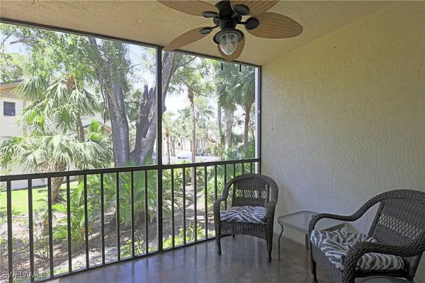 a view of a balcony with furniture