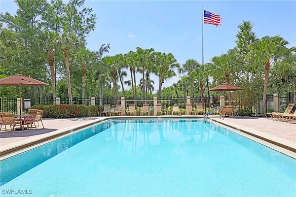 a view of a house with swimming pool and sitting area