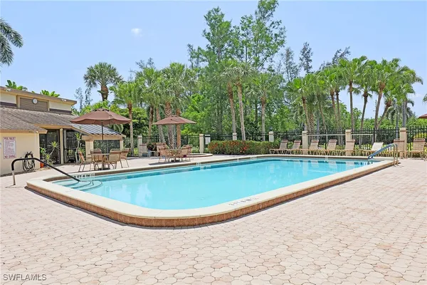 swimming pool view with a seating space and a garden view
