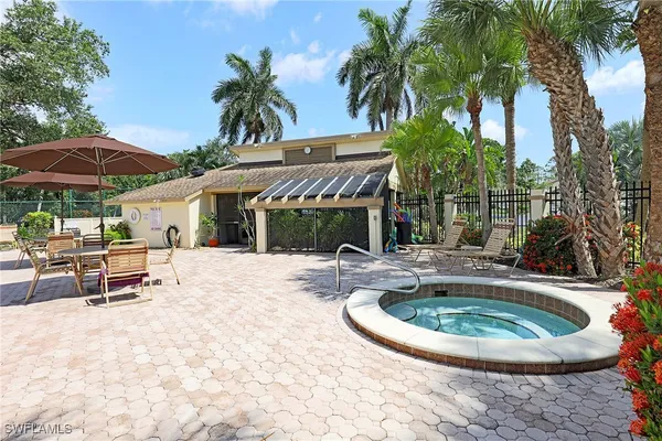 a view of a house with swimming pool and sitting area