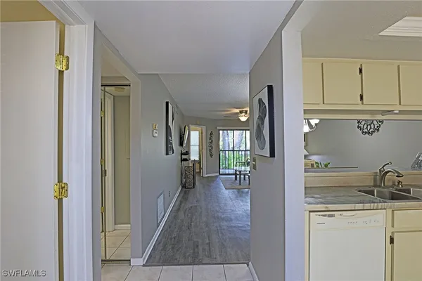 a view of a hallway to a livingroom and a livingroom with furniture