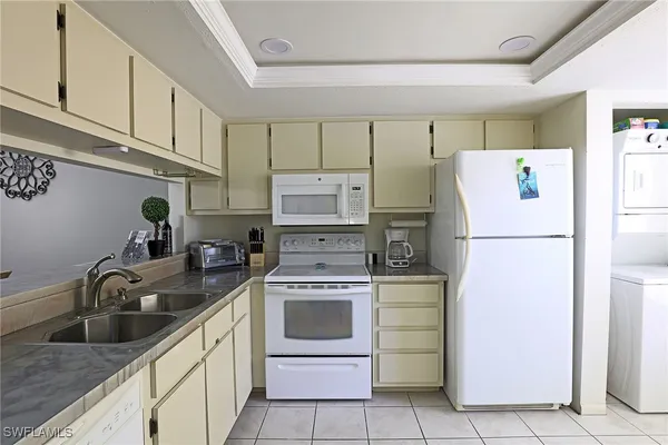 a kitchen with a sink cabinets and stainless steel appliances