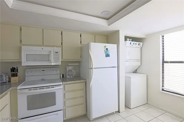 a kitchen with a refrigerator sink stove and cabinets
