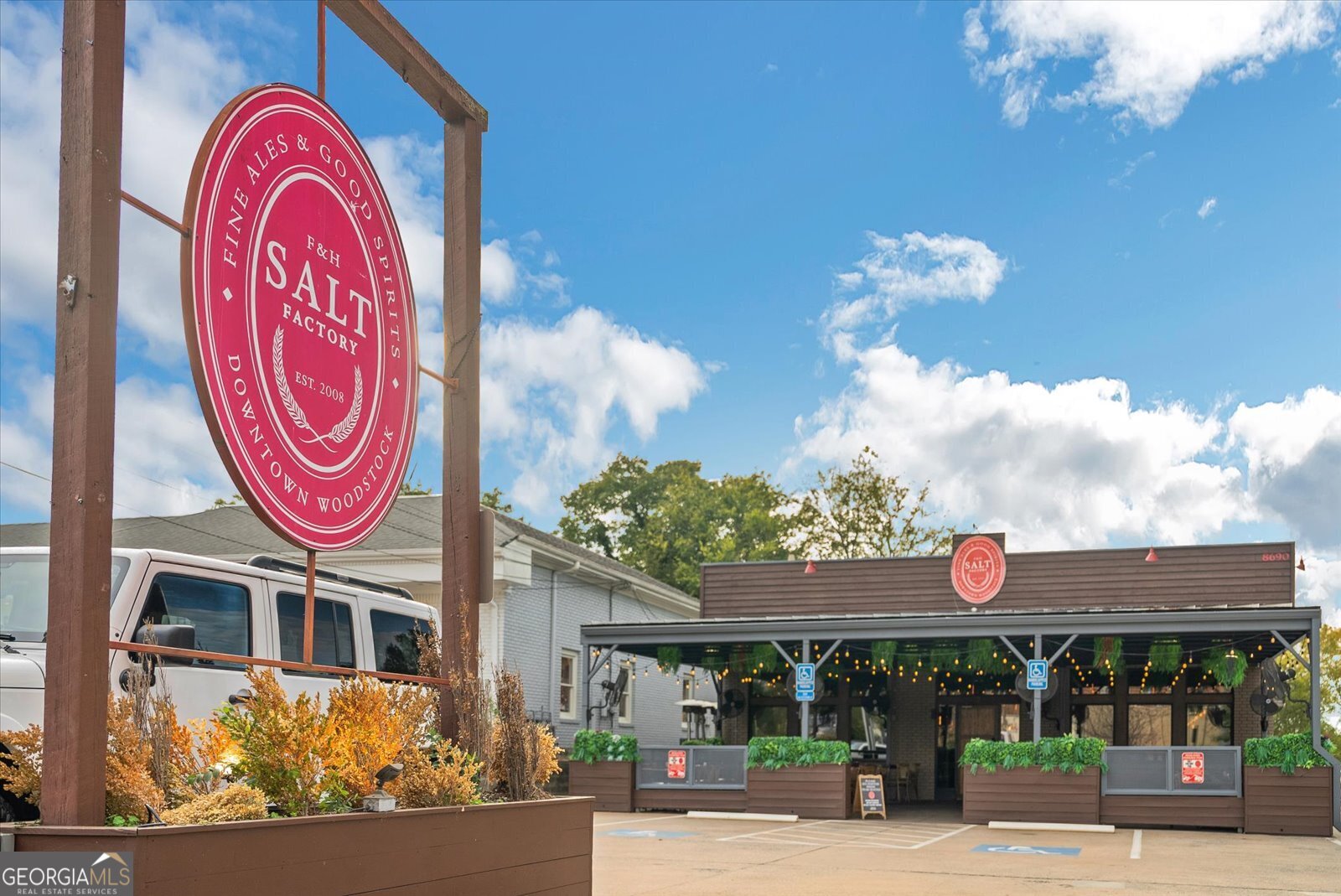 360 Chambers Street Woodstock, GA 30188 - Photo 49 of 50 a front view of multi story residential apartment building with retail shop and sign board