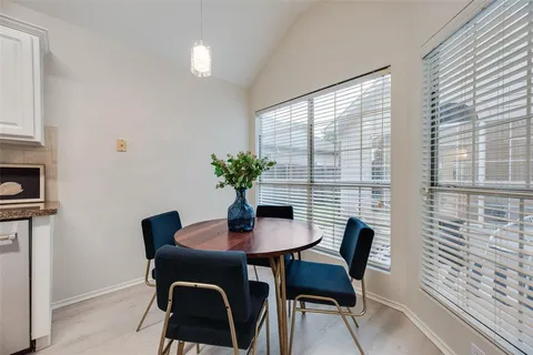 a dining room with furniture and window