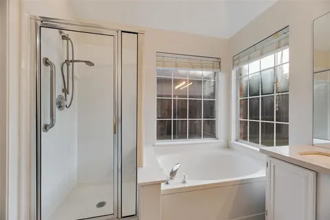 a bathroom with a bathtub and a shower
