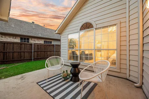 a front view of a house with patio and outdoor seating