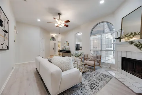 a living room with furniture a fireplace and a chandelier