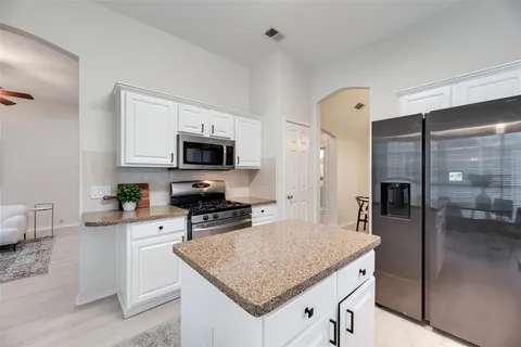 a kitchen with a stove a sink and a refrigerator