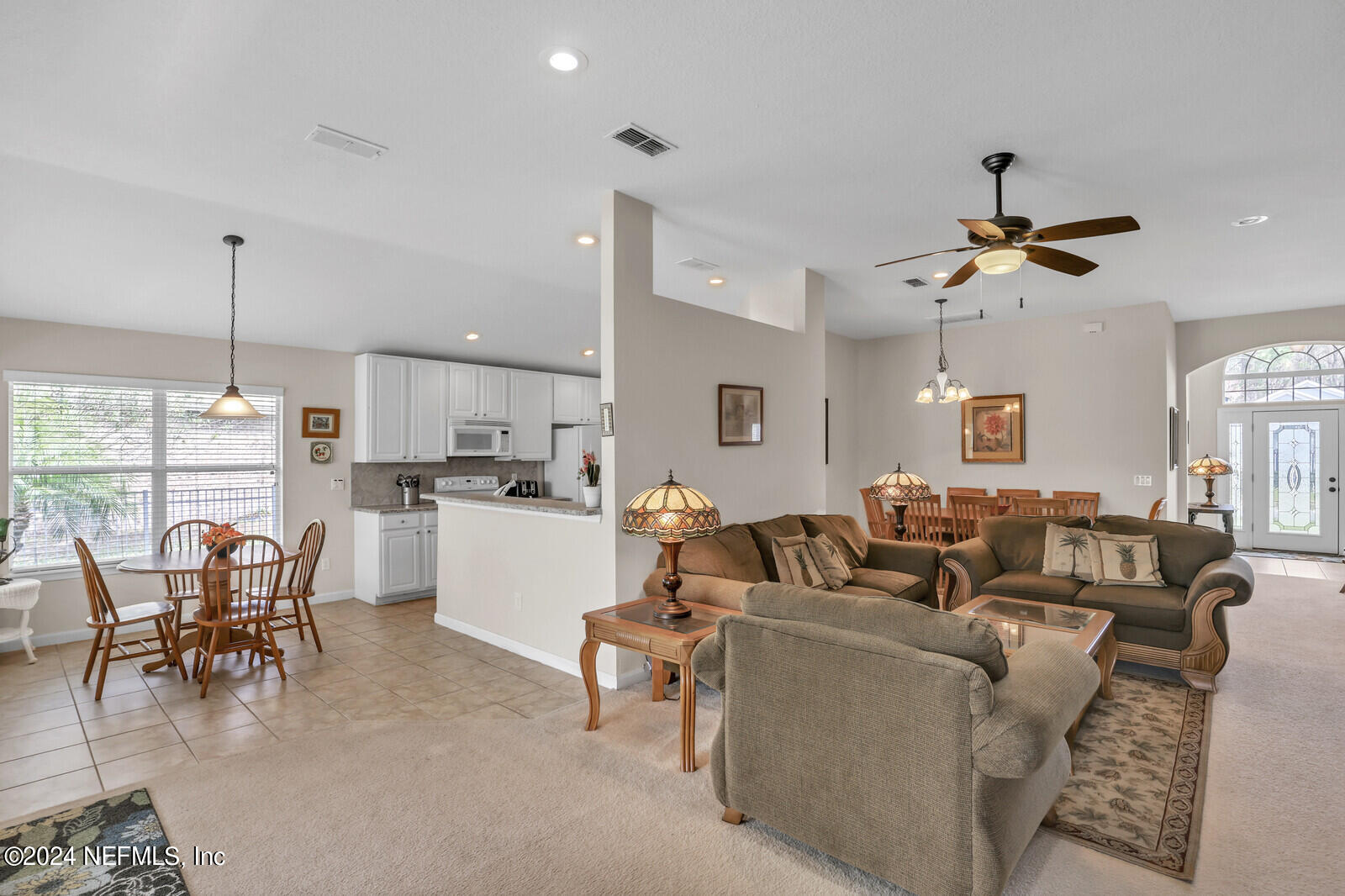 810 East Red House Branch Road St. Augustine, FL 32084 - Photo 13 of 33 a living room with furniture kitchen view and a chandelier