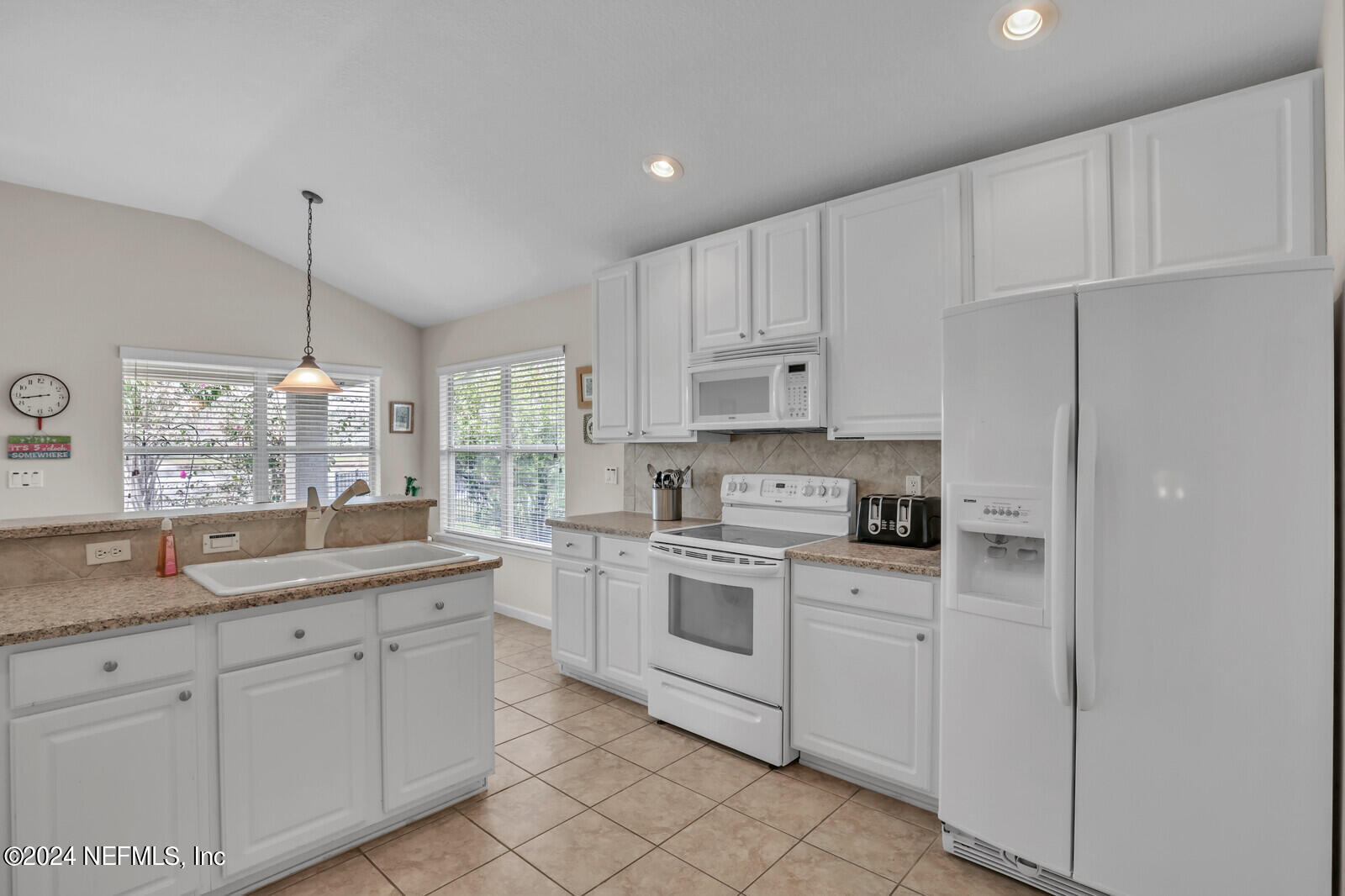 810 East Red House Branch Road St. Augustine, FL 32084 - Photo 17 of 33 a kitchen with white cabinets and white appliances