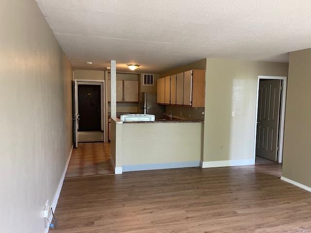 111 Kahului Beach Road, Unit C213 Kahului, HI 96732 - Photo 3 of 8 a view of a kitchen with wooden floor
