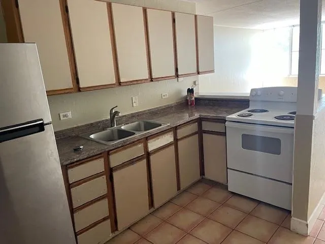 a kitchen with a sink stove and cabinets