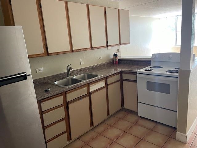111 Kahului Beach Road, Unit C213 Kahului, HI 96732 - Photo 6 of 8 a kitchen with a sink stove and cabinets