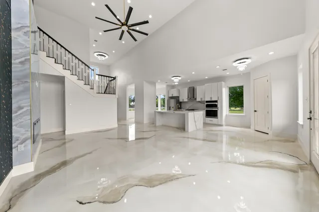 a kitchen with kitchen island granite countertop a stove a sink a refrigerator and a microwave