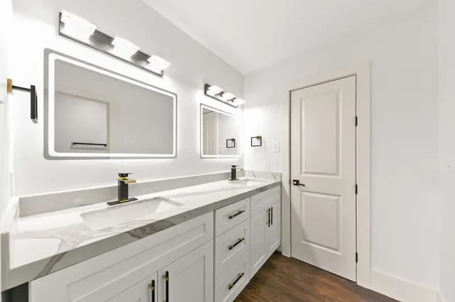 a bathroom with a sink a vanity and a mirror