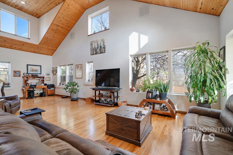 7025 Bluebird Lane Sweet, ID 83670 - Photo 11 of 46 Living area featuring wooden ceiling, high vaulted ceiling, and light wood-style flooring