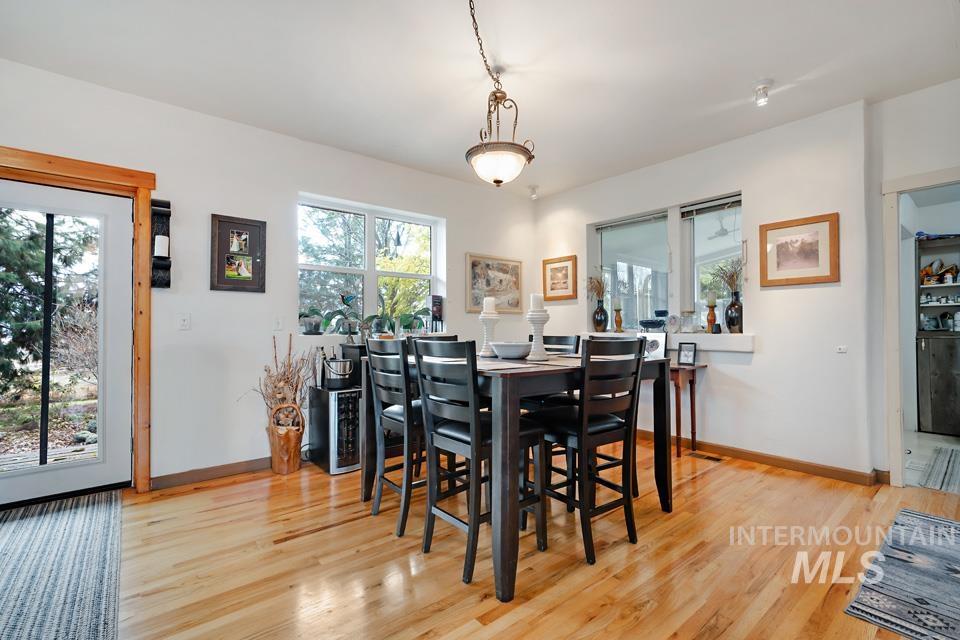 7025 Bluebird Lane Sweet, ID 83670 - Photo 22 of 46 Dining space with light wood-style flooring and baseboards