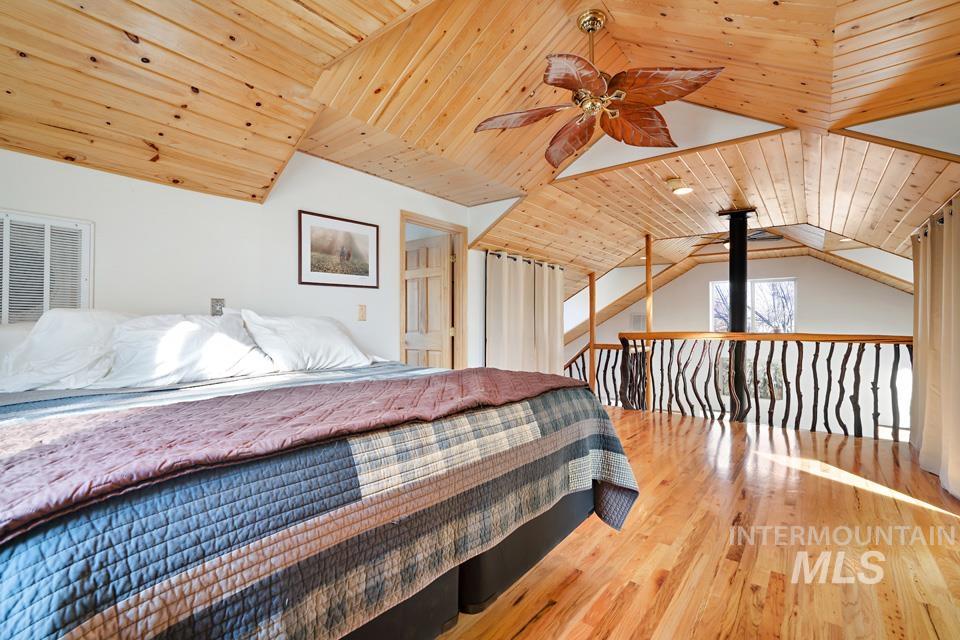7025 Bluebird Lane Sweet, ID 83670 - Photo 25 of 46 Bedroom with wood ceiling, vaulted ceiling, light wood finished floors, and ceiling fan