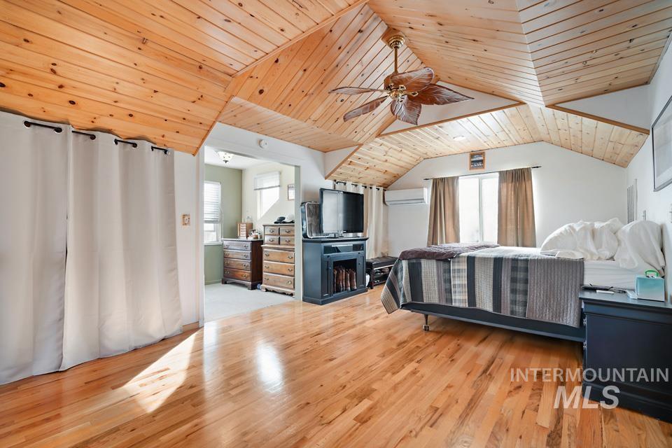 7025 Bluebird Lane Sweet, ID 83670 - Photo 26 of 46 Bedroom featuring wooden ceiling, multiple windows, light wood-style flooring, a ceiling fan, and lofted ceiling