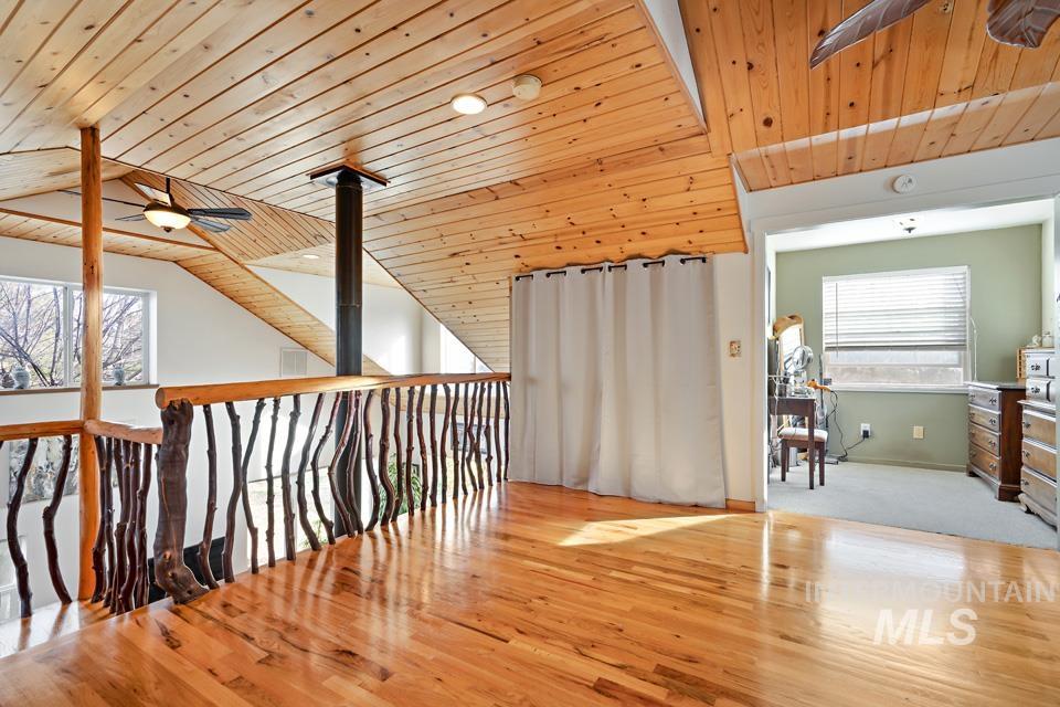 7025 Bluebird Lane Sweet, ID 83670 - Photo 27 of 46 Hallway with light wood finished floors, wooden ceiling, and lofted ceiling