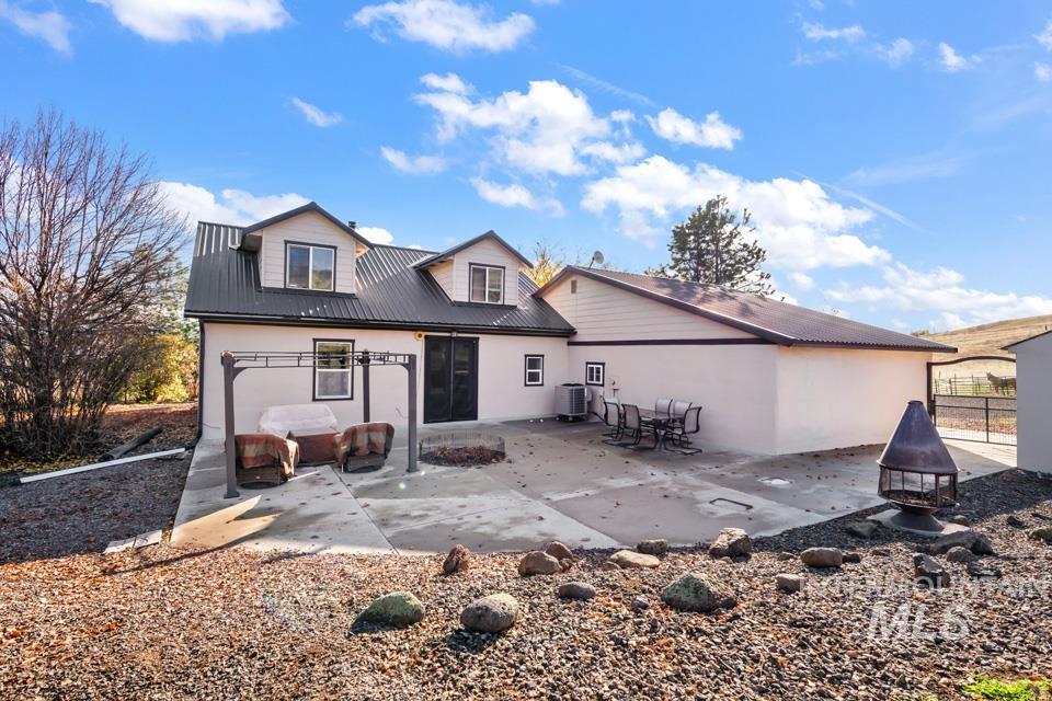 7025 Bluebird Lane Sweet, ID 83670 - Photo 3 of 46 Back of house featuring a patio and a metal roof