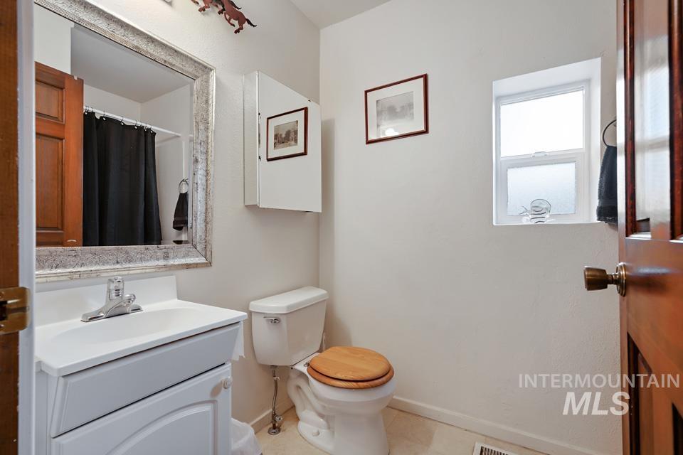 7025 Bluebird Lane Sweet, ID 83670 - Photo 34 of 46 Bathroom featuring a shower with curtain, vanity, and light tile patterned floors