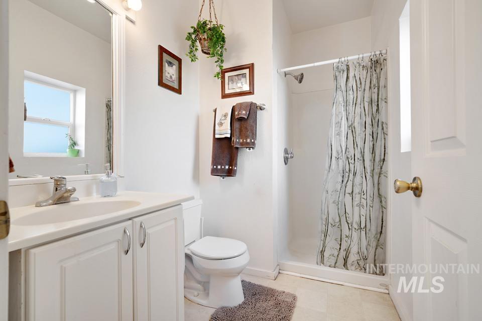 7025 Bluebird Lane Sweet, ID 83670 - Photo 37 of 46 Full bathroom with vanity and a shower stall