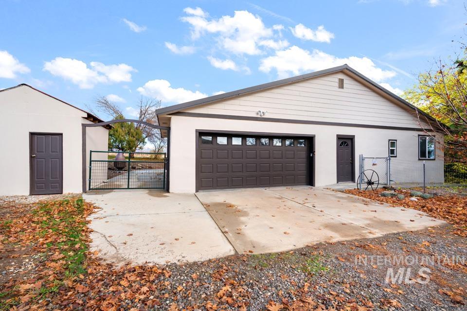 7025 Bluebird Lane Sweet, ID 83670 - Photo 4 of 46 Garage with a gate and driveway